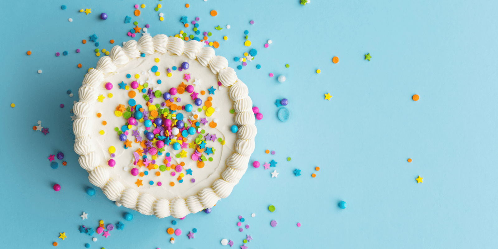 white cake with colourful sprinkles on top