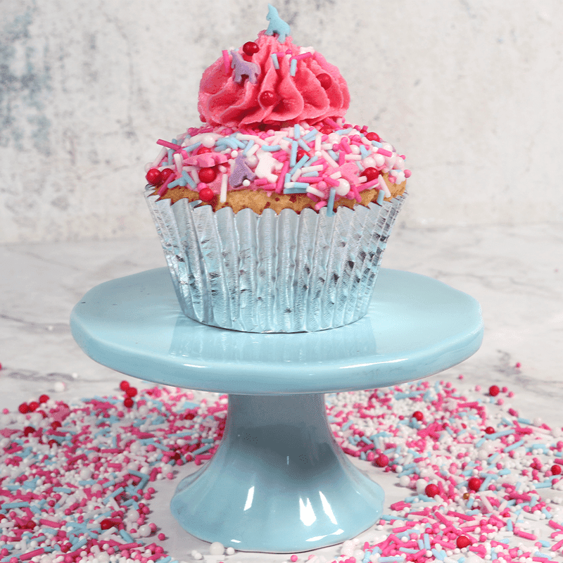 bright coloured cupcake on a blue cake stand