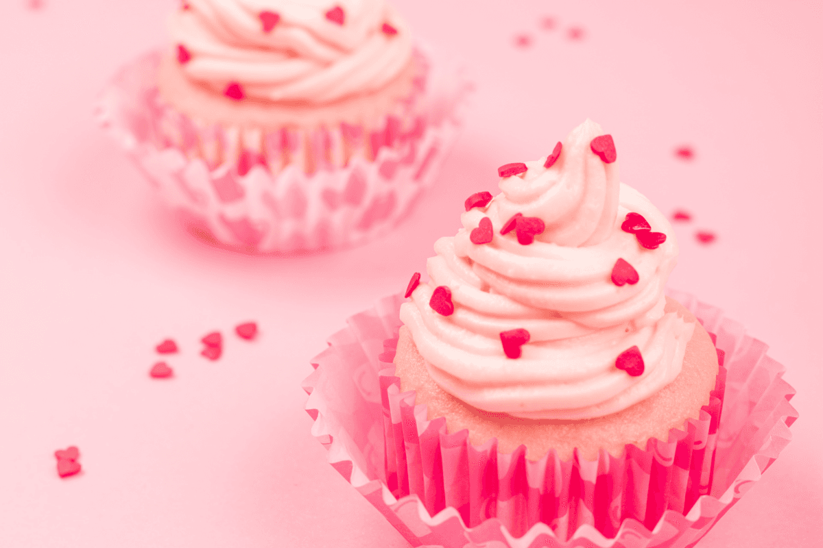 pink cupcakes with cream toppings and pink sprinkles